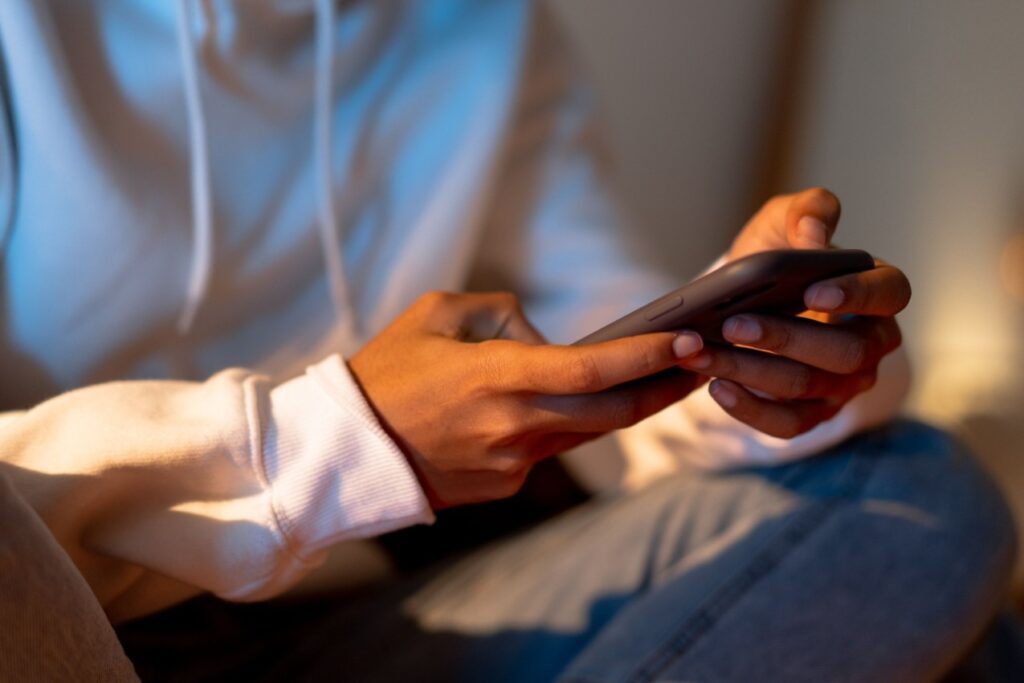 Homeowner searching for a local plumber on their smartphone late at night