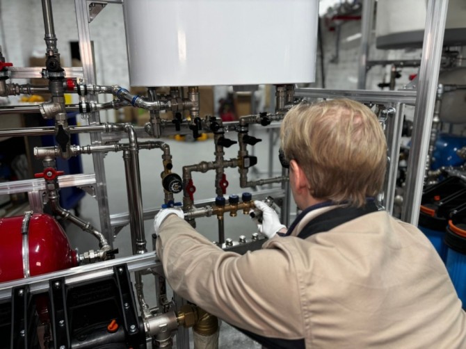 Plumber working on pipes — example of a trades business that uses real photos on their website